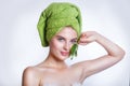 Young beautiful woman with a green towel on her head