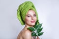 Young beautiful woman with a green towel on her head