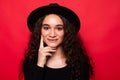 Young beautiful woman with hand on chin thinking about question, pensive expression wearing t-shirt standing over isolated red Royalty Free Stock Photo