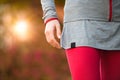 Young beautiful woman hands detail workout training. Autumn running fitness girl in city urban park environment wit