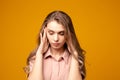 Young beautiful woman has headache, isolated on gray background Royalty Free Stock Photo