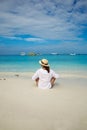 Young beautiful woman in a hat on a deserted tropical beach. Relaxation concept Royalty Free Stock Photo