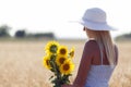 Young beautiful woman with a hat in a field with dry grass Royalty Free Stock Photo