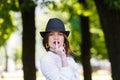 Young beautiful woman in hat shows hush sign