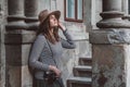 Young beautiful woman in hat is taking picture with old fashioned camera, outdoors Royalty Free Stock Photo