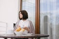 Young beautiful woman having breakfast on a cozy terrace Royalty Free Stock Photo