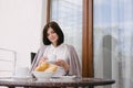 Young beautiful woman having breakfast on a cozy terrace Royalty Free Stock Photo