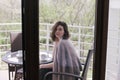 Young beautiful woman having breakfast on a cozy terrace Royalty Free Stock Photo