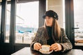 Young beautiful woman having a coffee in a cafe Royalty Free Stock Photo