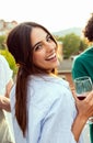 Young beautiful woman having fun dancing with friends at rooftop summer party Royalty Free Stock Photo