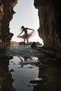 Young beautiful woman having fun dancing under rock archway