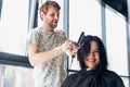 Young beautiful woman having her hair cut at the hairdresser`s. Enjoying the process of making a new hair style. Royalty Free Stock Photo