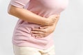 Young beautiful woman having painful stomachache on white background.Chronic gastritis. Abdomen bloating concept