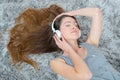 Young beautiful woman headphones listening music on floor Royalty Free Stock Photo