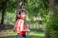 Young beautiful woman in headphones with water bottle looking back at camera, Sport woman at summer green park Royalty Free Stock Photo