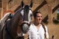 Young and beautiful woman with her horse, resting with him, caressing him, happy in the countryside. Concept horse riding, animals Royalty Free Stock Photo