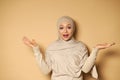 Young beautiful woman in hijab looks at the camera expressing astonishment and surprise. Stylish beautiful traditional formal