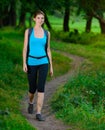Young Beautiful Woman Hiking in the Green Summer Forest Royalty Free Stock Photo