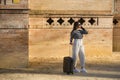 Young and beautiful woman, Hispanic, brown hair, with striped sweater, linen pants and sunglasses, waiting, talking on her cell Royalty Free Stock Photo