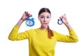 Young beautiful woman holding big and small clocks Royalty Free Stock Photo