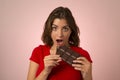 young beautiful woman holding and biting big chocolate bar skipping diet in sugar addiction and unhealthy nutrition Royalty Free Stock Photo