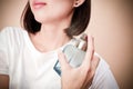 Young beautiful woman holding bottle of perfume and smelling aroma. Royalty Free Stock Photo