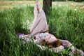 Young Beautiful Woman Holding Bunch Of Dandelion Flowers Lying On Green Grass. Royalty Free Stock Photo