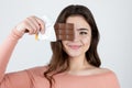 Young beautiful woman holding chocolate bar near her face looking excited standing on isolated white background, healthy sweets Royalty Free Stock Photo