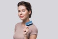 Young beautiful woman holding credit card isolated on white background. Online shopping, e-commerce, internet banking concept Royalty Free Stock Photo