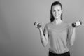 Young beautiful woman holding dumbbells ready for exercise Royalty Free Stock Photo