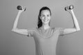 Young beautiful woman holding dumbbells ready for exercise Royalty Free Stock Photo