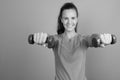 Young beautiful woman holding dumbbells ready for exercise Royalty Free Stock Photo