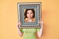 Young beautiful woman holding empty frame depressed and worry for distress, crying angry and afraid Royalty Free Stock Photo