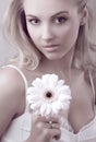 Young beautiful woman holding flower