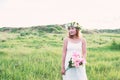 Young beautiful woman holding flower on her hands and smiley. Royalty Free Stock Photo