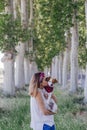 Young beautiful woman holding her cute small dog outdoors and kissing her dog. Love for animals concept and lifestyle outdoors Royalty Free Stock Photo