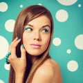 Young beautiful woman holding a turquoise bracelet with bright c