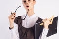 Young beautiful woman holds glasses on white isolated background, portrait, teacher