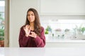 Young beautiful woman at home disgusted expression, displeased and fearful doing disgust face because aversion reaction Royalty Free Stock Photo