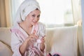 Young beautiful woman in a house dressing gown and with a towel