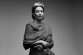 Young beautiful woman in the image of the famous artist Frida Kahlo posing isolated on a gray background. Black and white