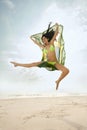 Young beautiful woman jumping on beach with Brazil flag Royalty Free Stock Photo