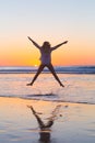 Young beautiful woman jumping in the beach. Royalty Free Stock Photo