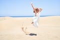 Young beautiful woman jumping crazy at maspalomas dunes beach Royalty Free Stock Photo