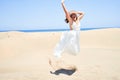 Young beautiful woman jumping crazy at maspalomas dunes beach Royalty Free Stock Photo