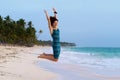 Young beautiful woman jumping on a tropical beach Royalty Free Stock Photo