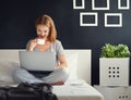 Young beautiful woman with laptop and cup of coffee in morni Royalty Free Stock Photo