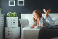 Young beautiful woman with laptop and cup of coffee in morni Royalty Free Stock Photo