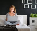 Young beautiful woman with laptop and cup of coffee in morni Royalty Free Stock Photo