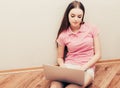 Young beautiful woman with laptop notebook on floor home surfing internet Royalty Free Stock Photo